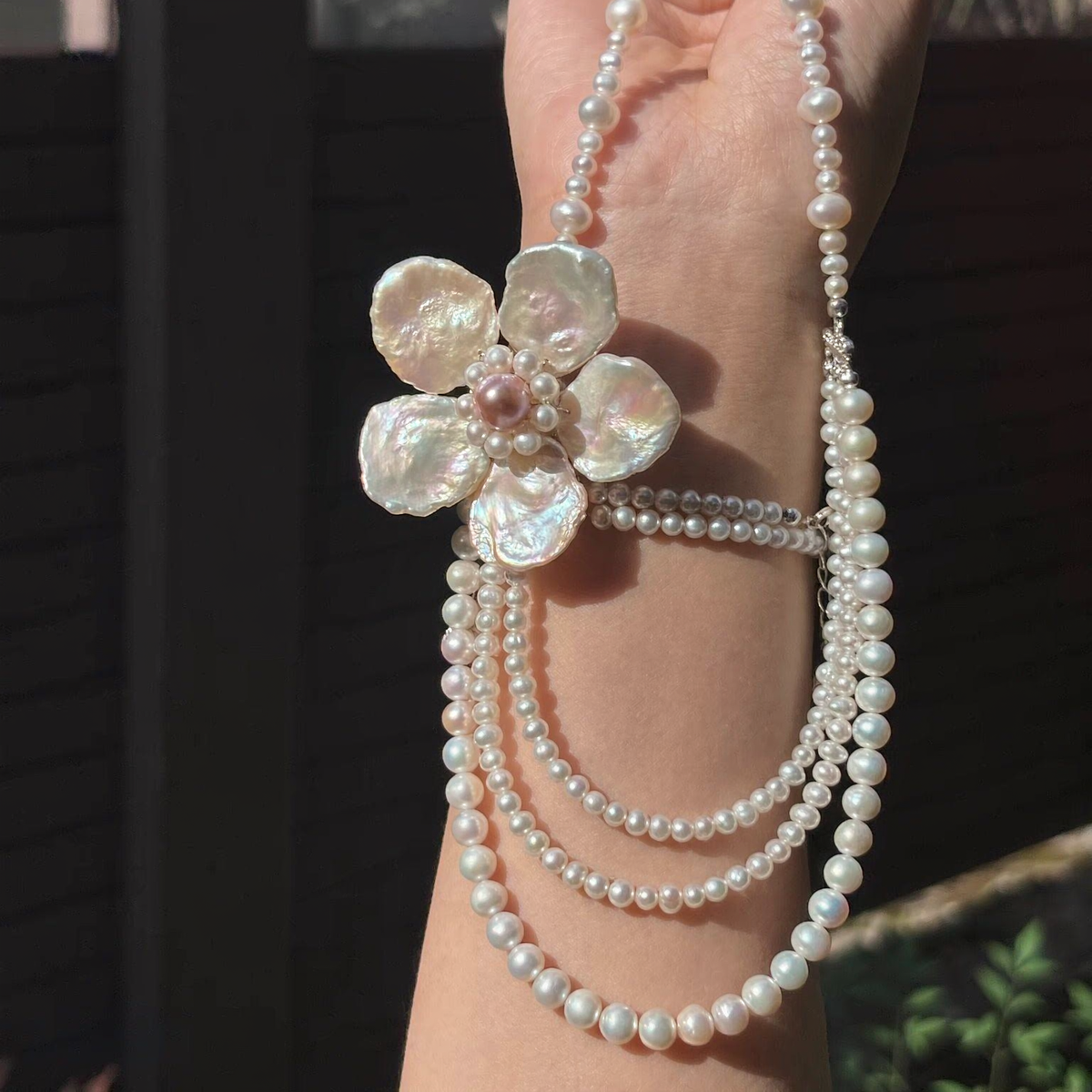 Front view of Grand Fleur Multi-Strand Pearl Necklace, a natural freshwater baroque pearl necklace for editorial bridal looks