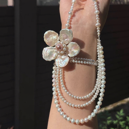 Front view of Grand Fleur Multi-Strand Pearl Necklace, a natural freshwater baroque pearl necklace for editorial bridal looks
