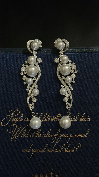 Front view of ornate grey drop high-lustre freshwater pearl earrings for wedding guest looks