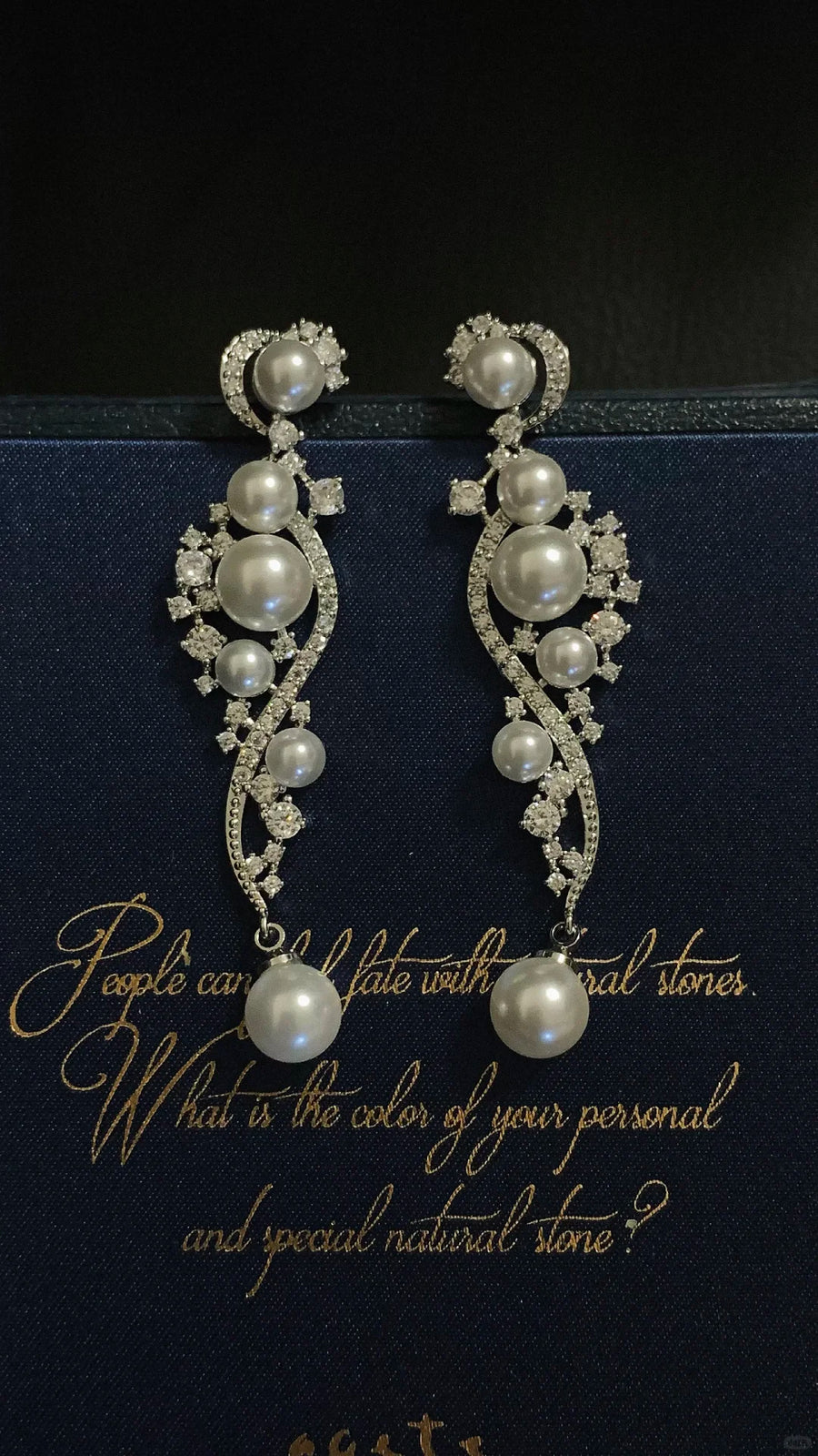 Front view of ornate grey drop high-lustre freshwater pearl earrings for wedding guest looks
