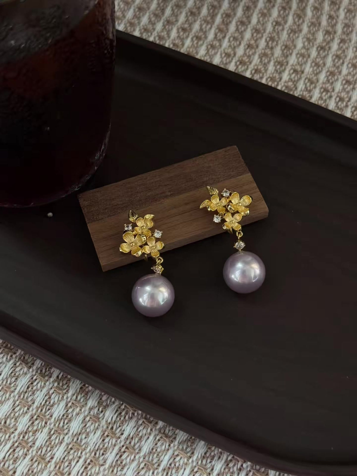 Styled view of vintage drop high-lustre freshwater pearl earrings for wedding guest looks