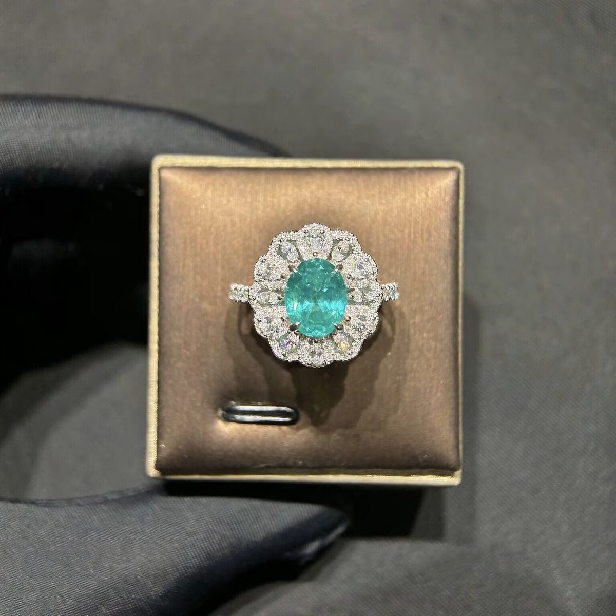 Front view of oval lab-grown Paraiba gemstone scalloped halo ring for engagement parties