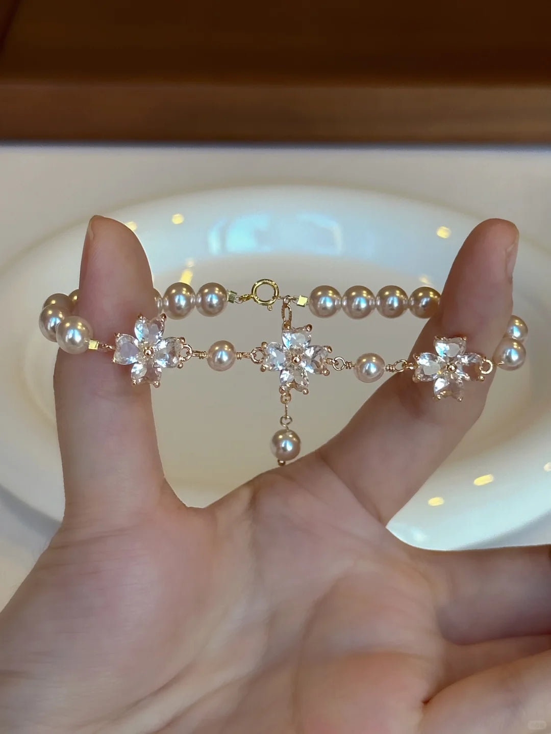 Close-up of floral motif high-lustre freshwater pearl bracelet for bridal styling