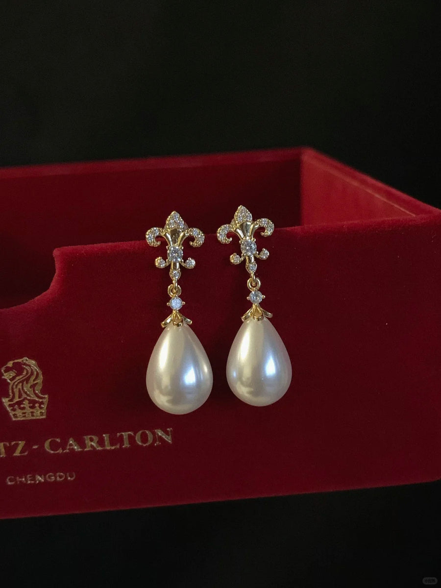Front view of pearl flower drop high-lustre freshwater pearl earrings for wedding guest looks