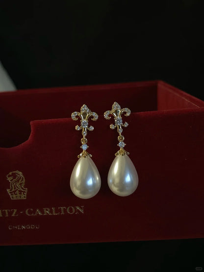 Styled view of pearl flower drop high-lustre freshwater pearl earrings for wedding guest looks