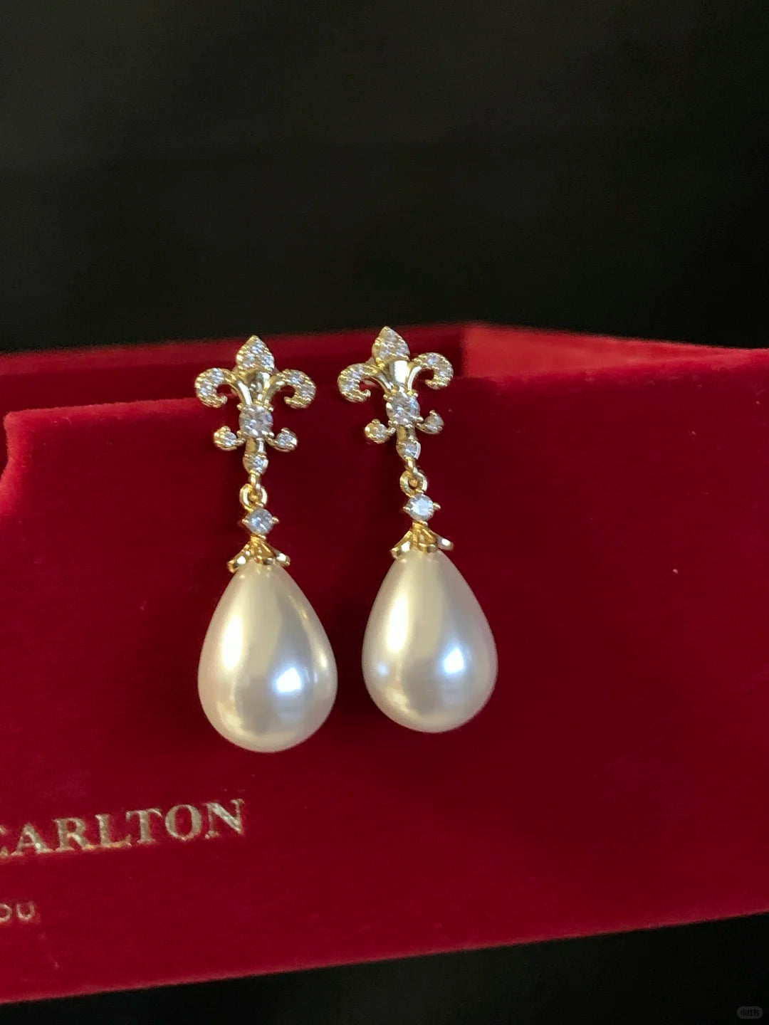 Close-up of pearl flower drop high-lustre freshwater pearl earrings for wedding guest looks