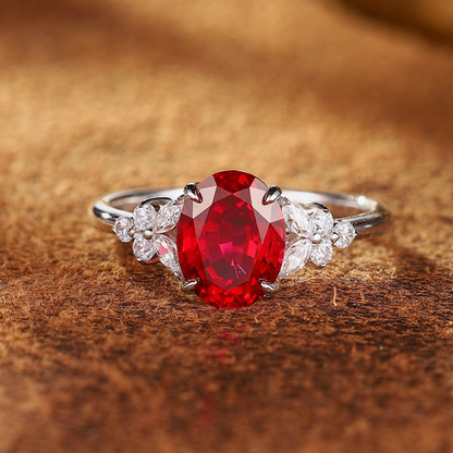 Front view of oval lab-grown ruby three-stone ring in 16K gold for engagement moments