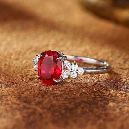Styled view of oval lab-grown ruby three-stone ring in 16K gold for engagement moments