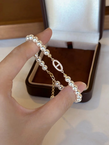 Styled view of half-chain high-lustre freshwater pearl bracelet for bridal styling