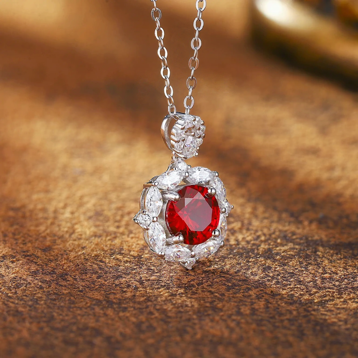 Close-up of oval lab-grown ruby halo pendant necklace in 16K gold for romantic gifts