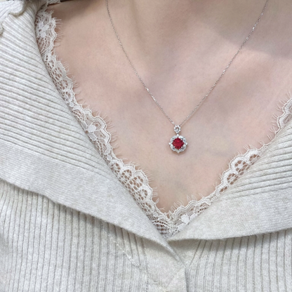 Styled view of oval lab-grown ruby halo pendant necklace in 16K gold for romantic gifts