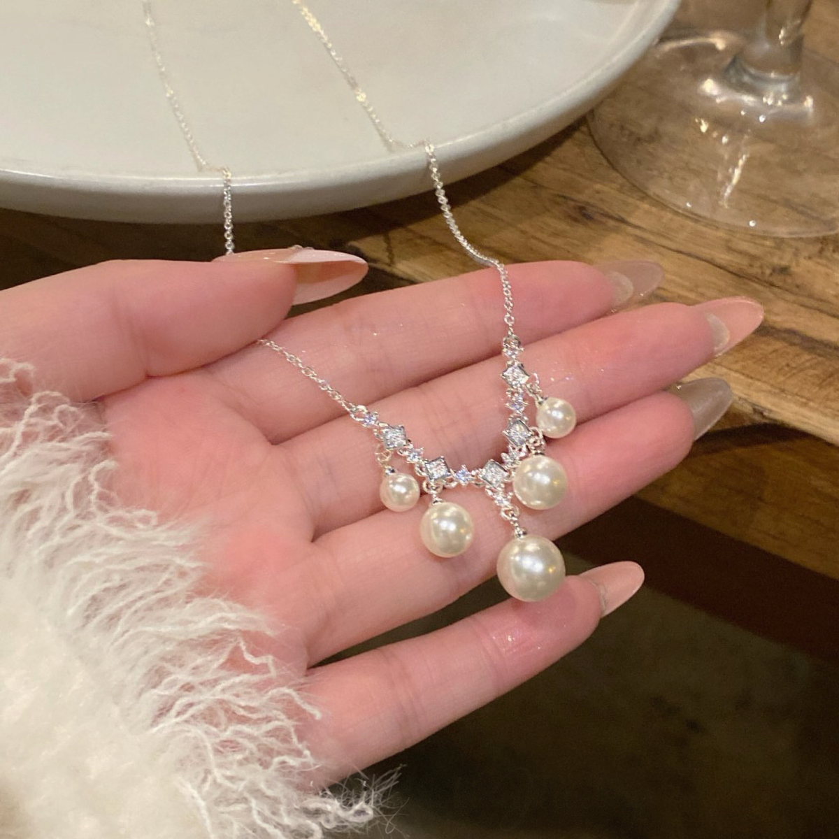 Detail view of cluster pendant high-lustre freshwater pearl necklace for weddings