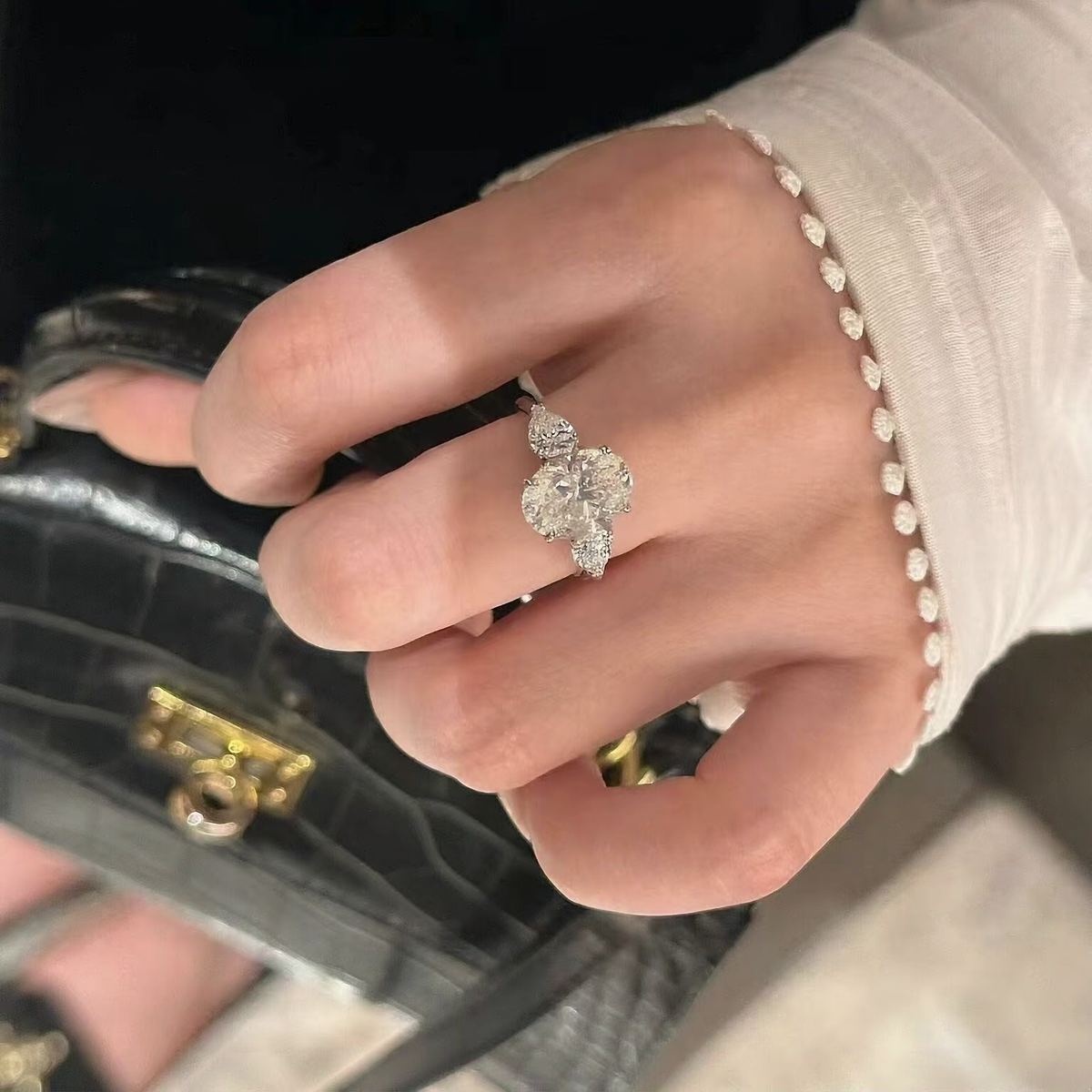 Close-up of oval lab-grown diamond three-stone engagement ring for engagement proposals