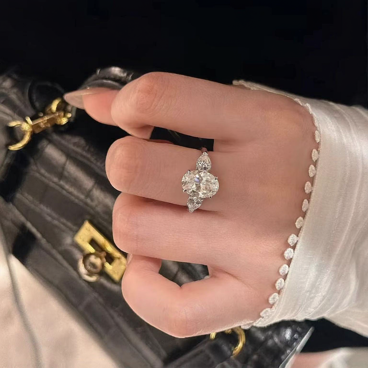 Styled view of oval lab-grown diamond three-stone engagement ring for engagement proposals