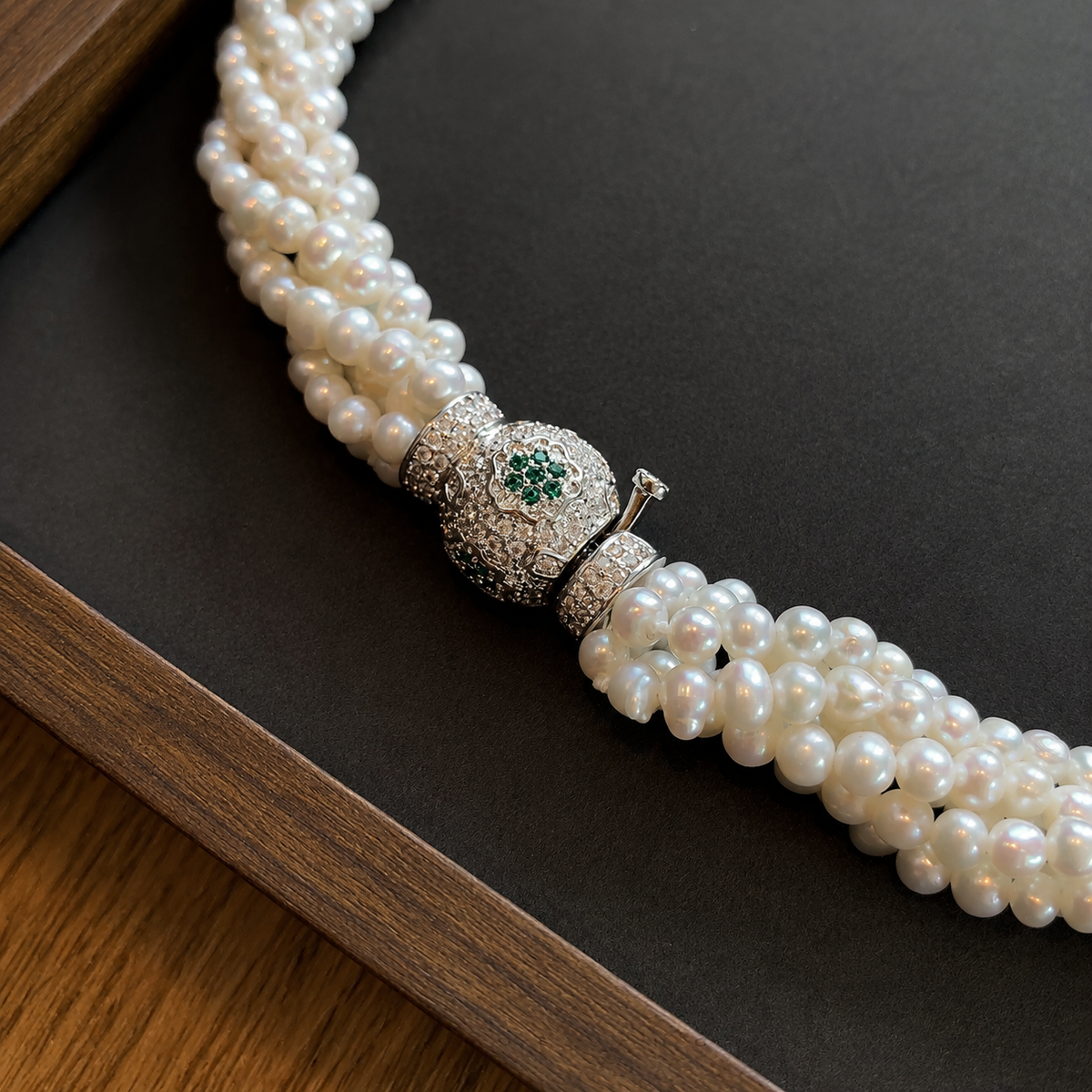 Close-up of the decorative clasp on a multi-strand pearl necklace