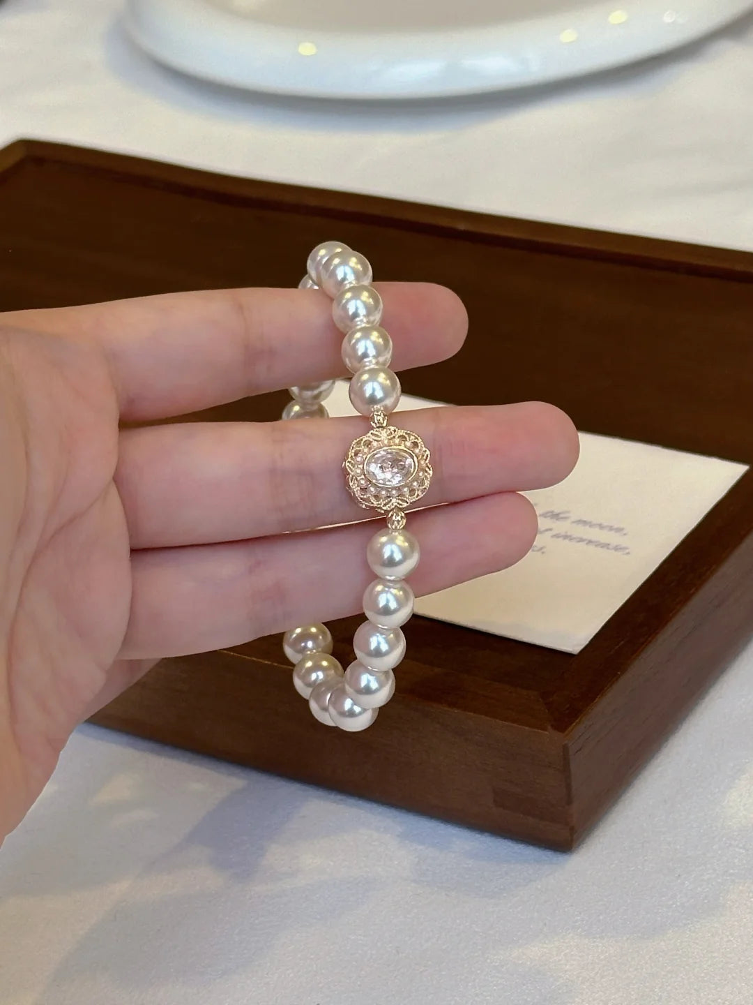 Front view of medallion high-lustre freshwater pearl bracelet for bridal styling