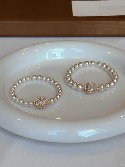 Styled view of medallion high-lustre freshwater pearl bracelet for bridal styling