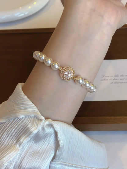 Detail view of medallion high-lustre freshwater pearl bracelet for bridal styling