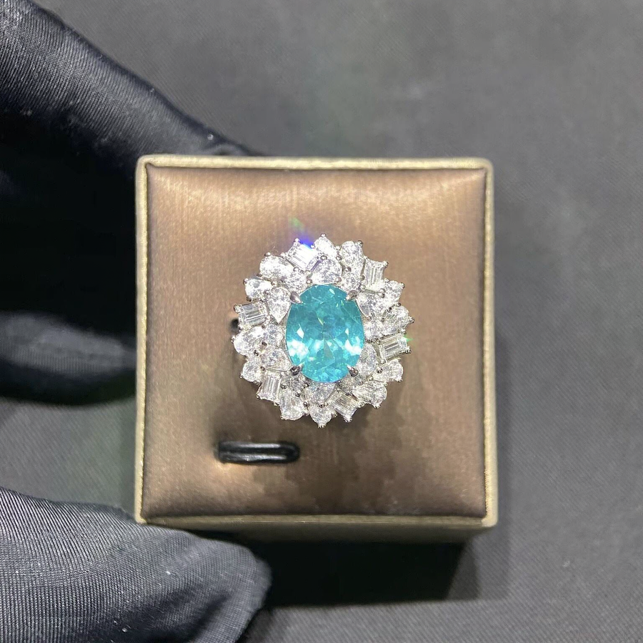 Front view of pear-cut lab-grown Paraiba gemstone halo ring for engagement moments