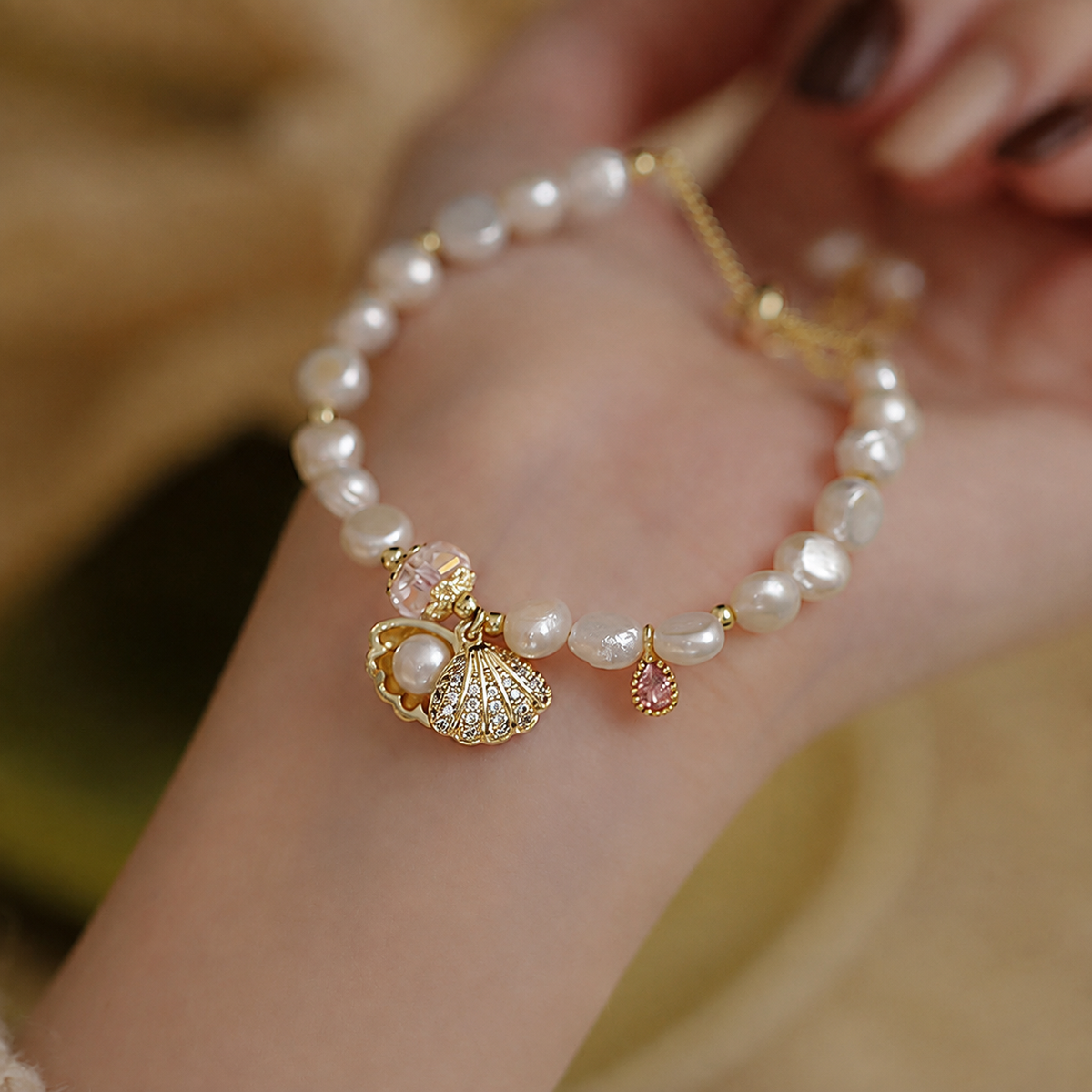 Close-up of a 6–7mm pearl bracelet with pink and clear accents
