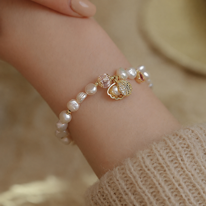 Adjustable freshwater pearl charm bracelet worn on the wrist