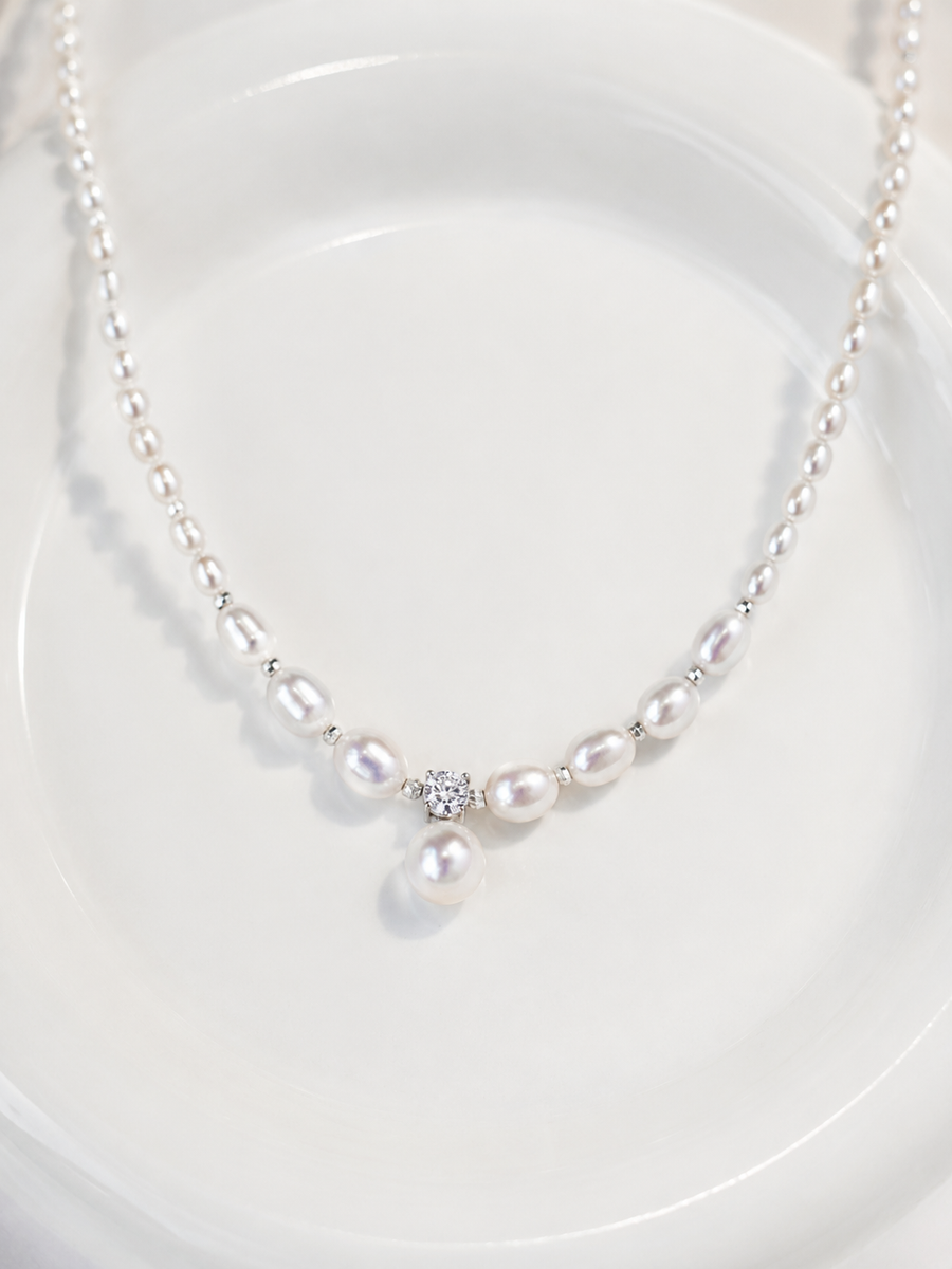 Mira freshwater pearl pendant necklace with silver spacers on a white background