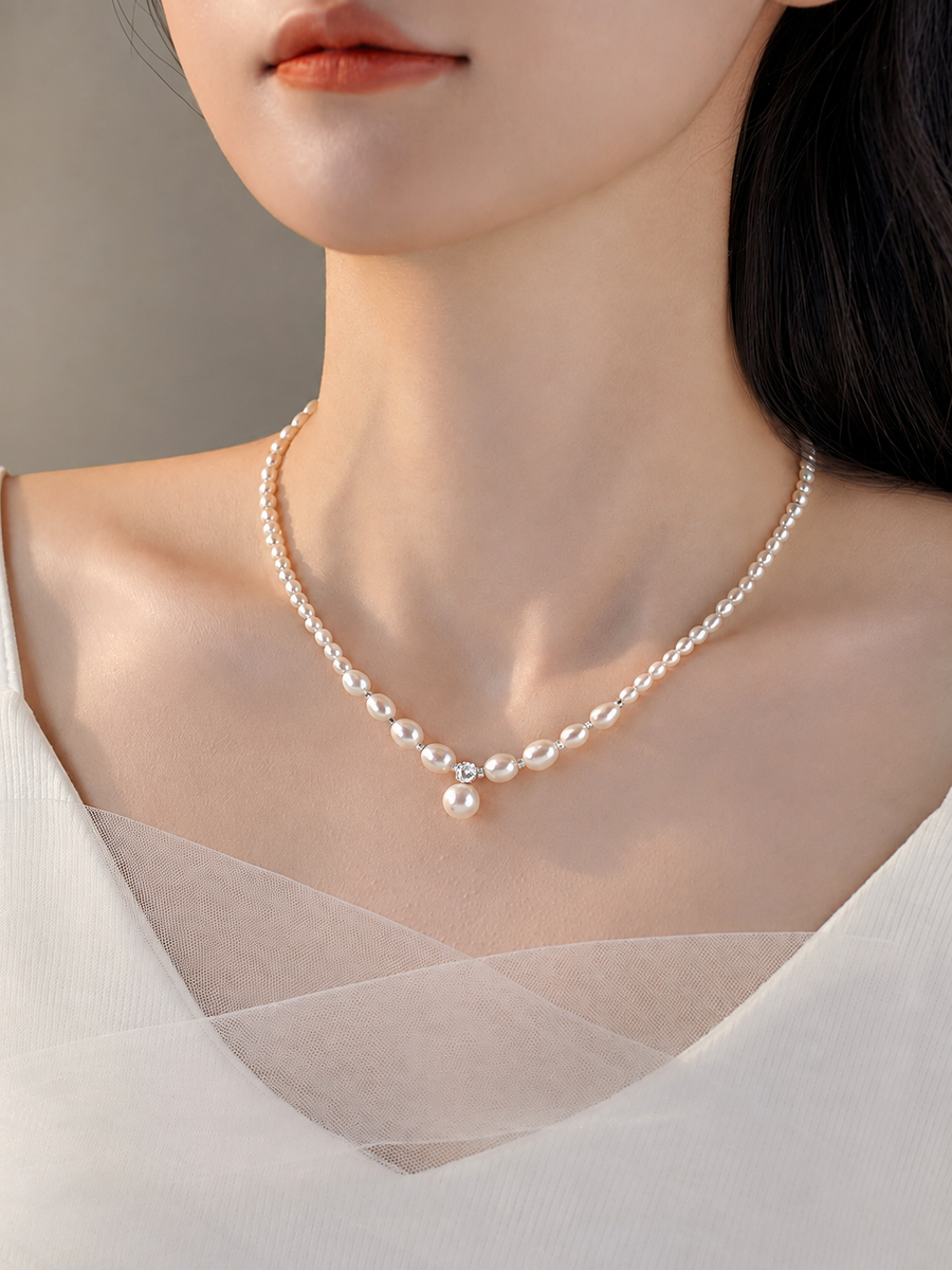 Model wearing a delicate freshwater pearl pendant necklace