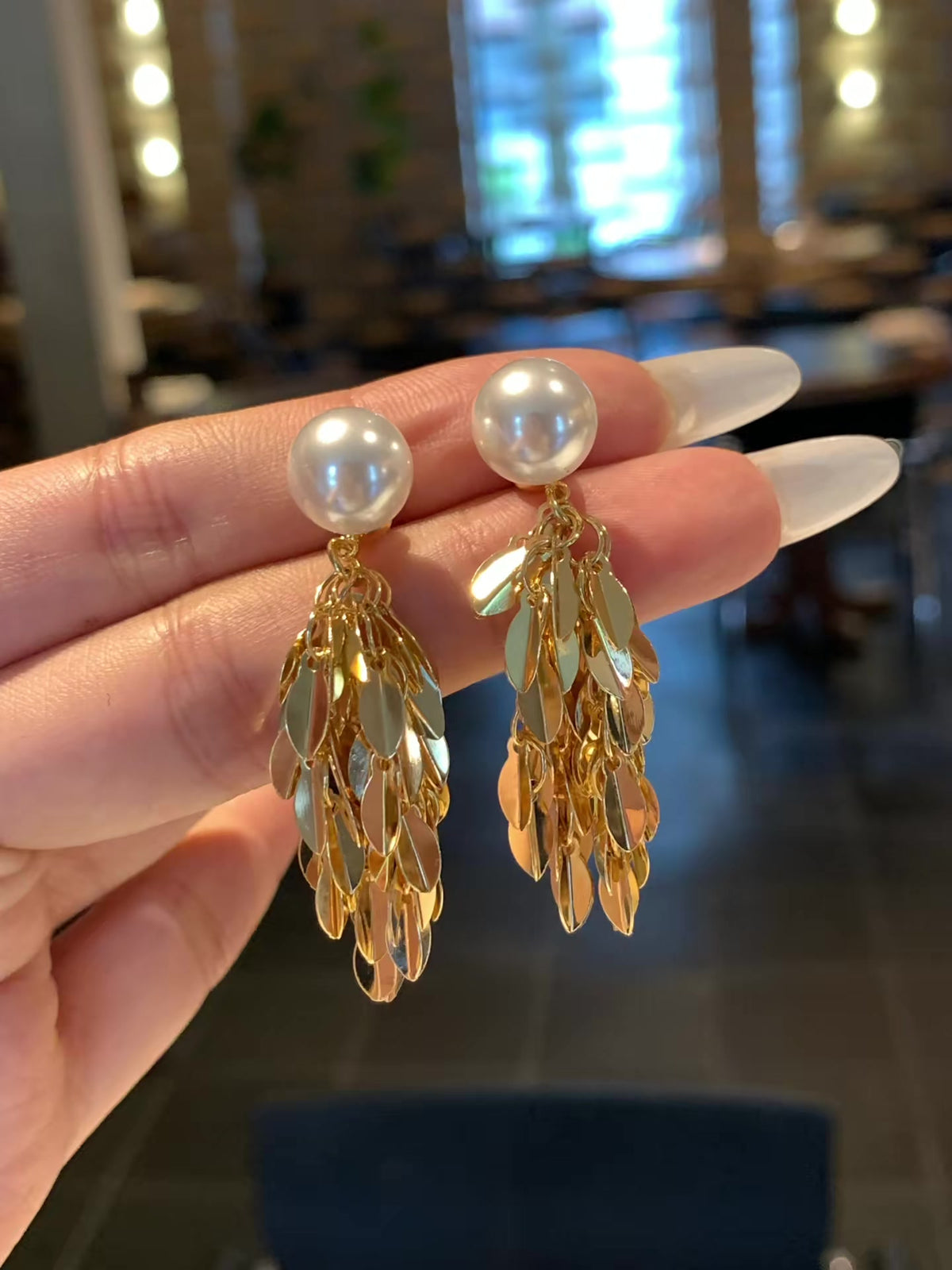 Styled view of vintage statement high-lustre freshwater pearl earrings for wedding guest looks