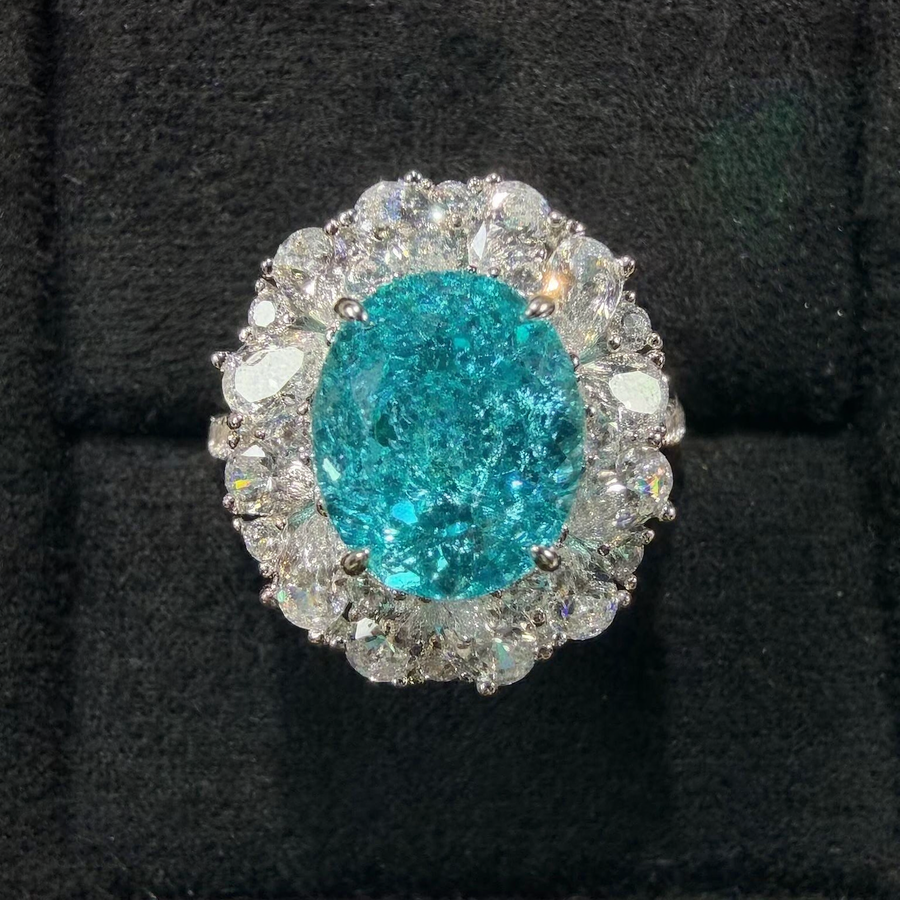 Front view of large oval lab-grown Paraiba gemstone halo ring for statement proposals