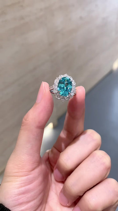 Close-up of lab-grown Paraiba blue halo statement ring for cocktail parties