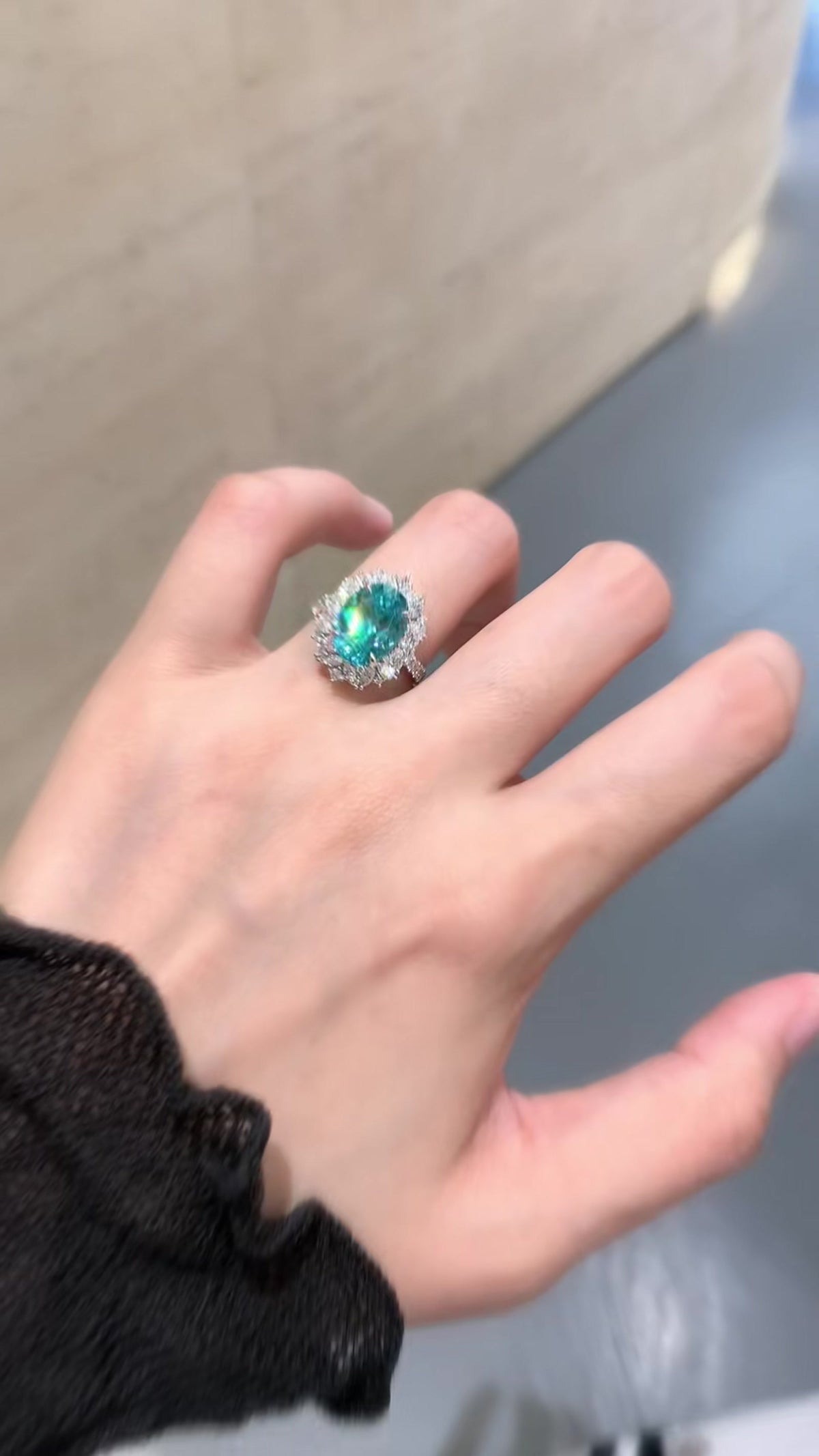 Styled view of lab-grown Paraiba blue halo statement ring for cocktail parties