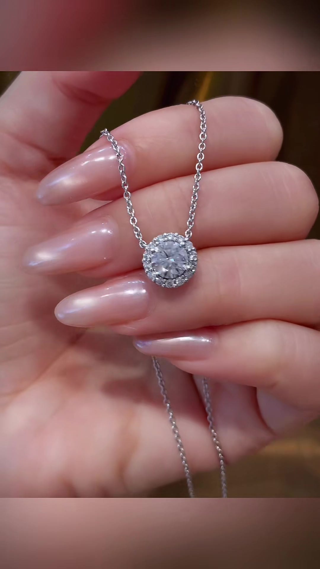 Close-up of lab-grown diamond oval halo pendant necklace for wedding receptions