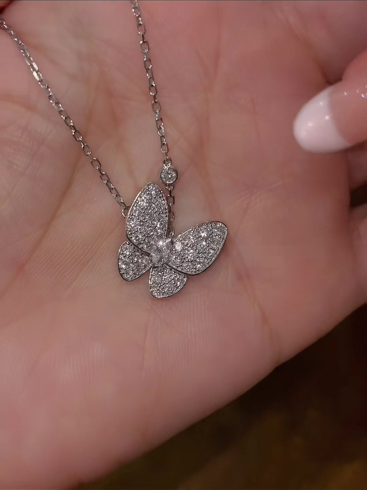 Close-up of lab-grown diamond butterfly pendant necklace for birthday gifts