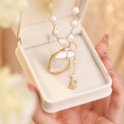 Mother-of-pearl butterfly and organic pearl pendant displayed in a gift box