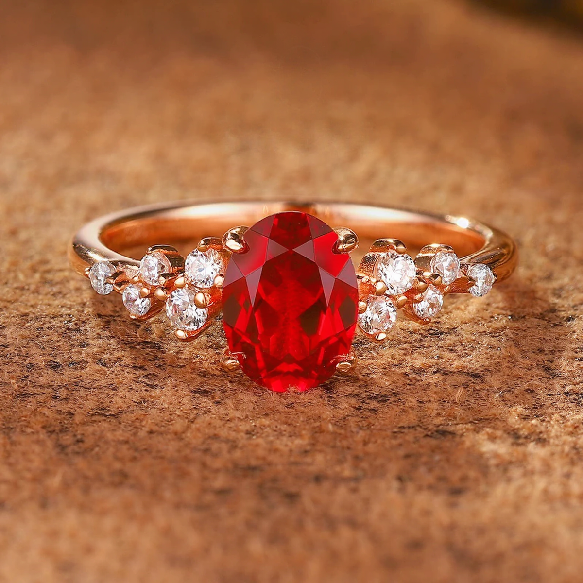 Detail view of delicate oval lab-grown ruby side-stone ring for everyday elegance