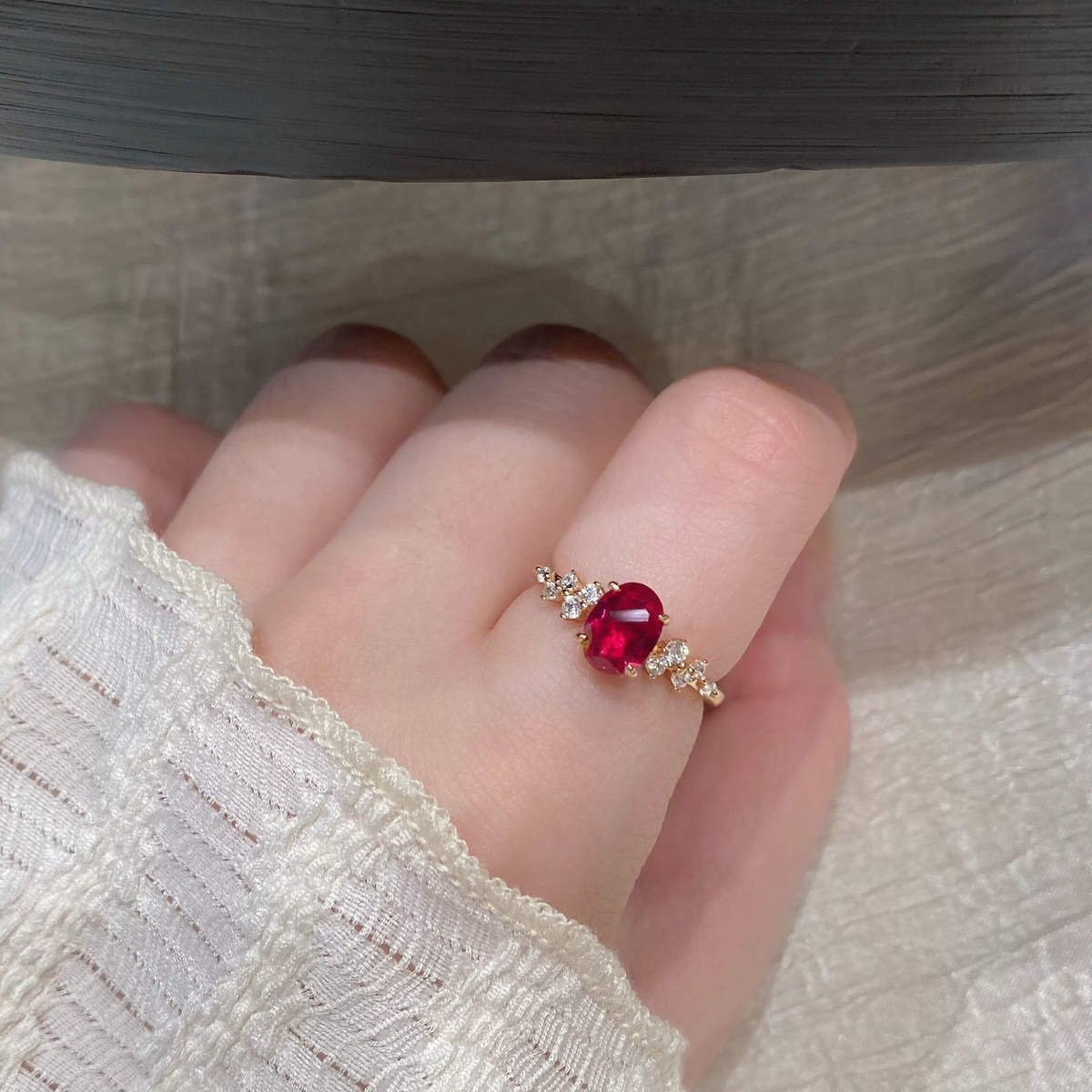 Side view of delicate oval lab-grown ruby side-stone ring for everyday elegance