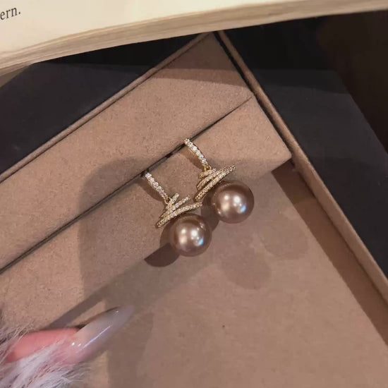 Video view of christmas tree high-lustre freshwater pearl earrings styled for wedding guest looks