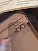 Video view of christmas tree high-lustre freshwater pearl earrings styled for wedding guest looks