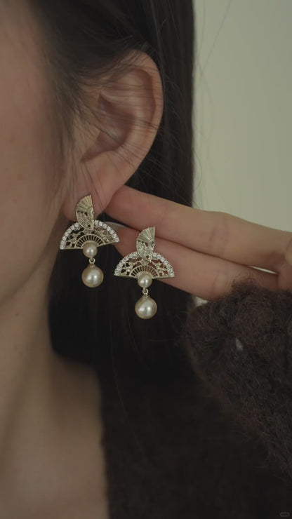 Video view of ornate drop high-lustre freshwater pearl earrings styled for wedding guest looks