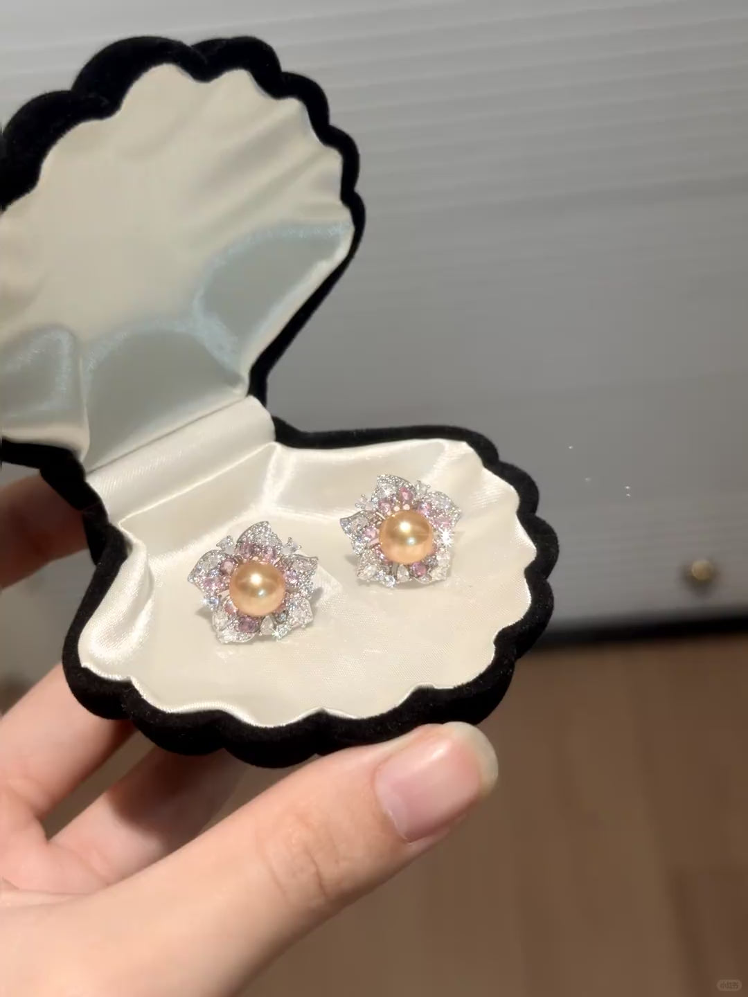 Video view of golden flower stud high-lustre freshwater pearl earrings styled for wedding guest looks