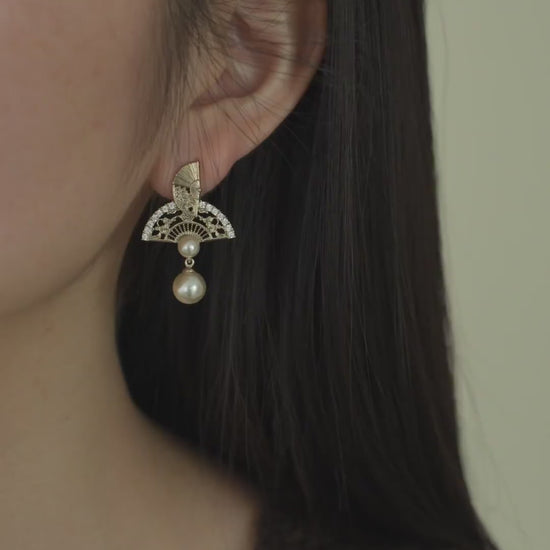 Video view of ornate drop high-lustre freshwater pearl earrings styled for wedding guest looks