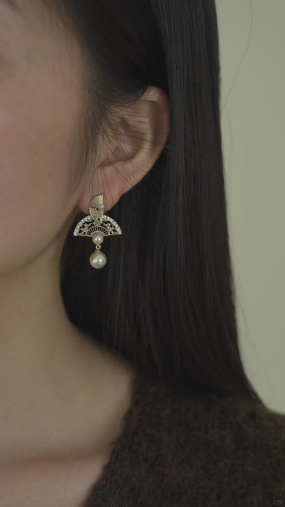 Video view of ornate drop high-lustre freshwater pearl earrings styled for wedding guest looks