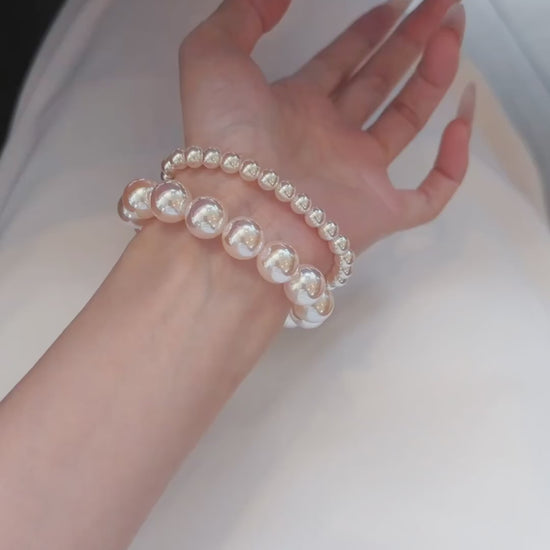 Video view of pink pearl high-lustre freshwater pearl bracelet styled for bridal styling