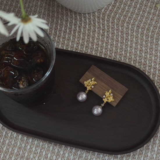 Video view of vintage drop high-lustre freshwater pearl earrings styled for wedding guest looks