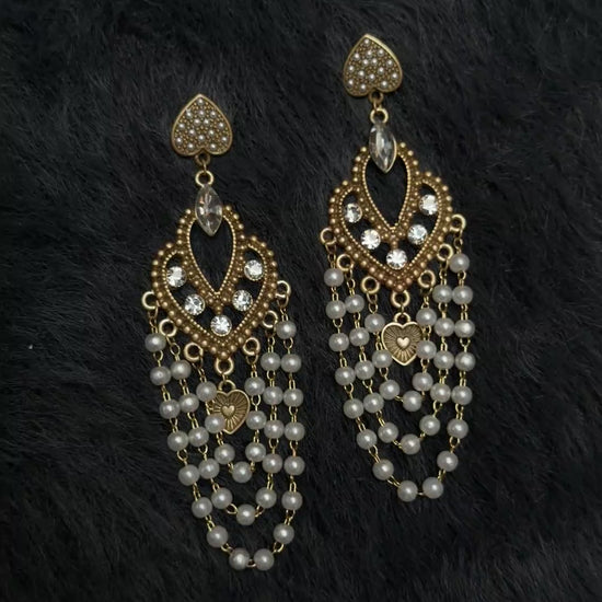 Video view of chandelier high-lustre freshwater pearl earrings styled for wedding guest looks