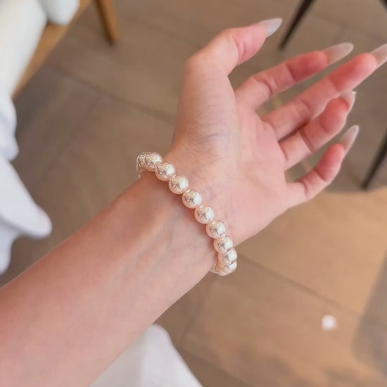 Video view of blush strand high-lustre freshwater pearl bracelet styled for bridal styling