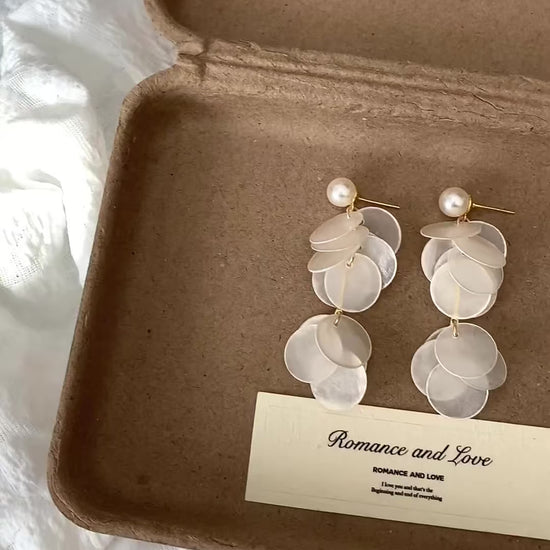 Video view of white shell drop high-lustre freshwater pearl earrings styled for wedding guest looks