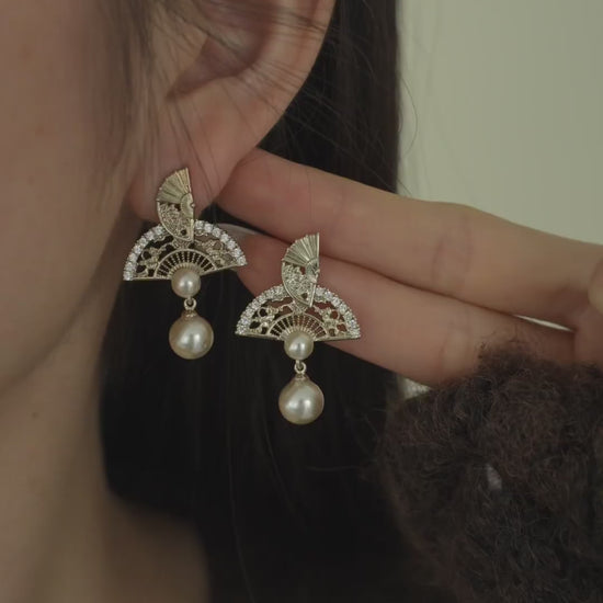 Video view of ornate drop high-lustre freshwater pearl earrings styled for wedding guest looks