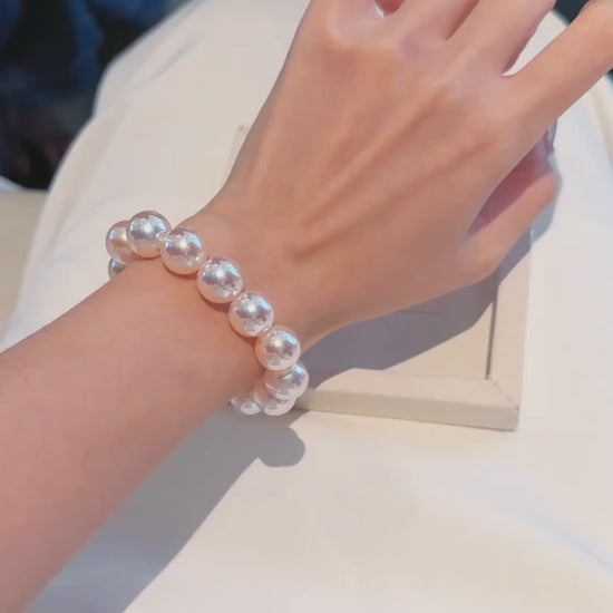 Video view of white strand high-lustre freshwater pearl bracelet styled for bridal styling
