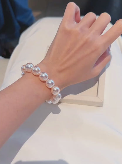 Video view of white strand high-lustre freshwater pearl bracelet styled for bridal styling